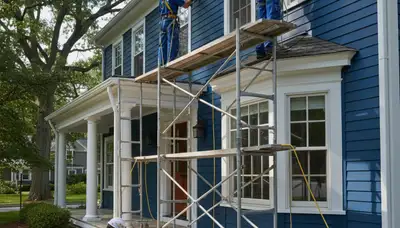 Wellesley, MA painting contractor at work on a residential home exterior